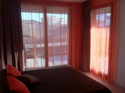a bedroom with a bed and a large window at Residence Ormeggio in Grado