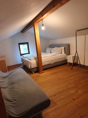 a bedroom with two beds and a chair in it at Apartment King Louie in Prien am Chiemsee