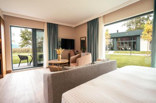 a bedroom with a bed and a couch and a living room at Wellwood Otel in Sapanca