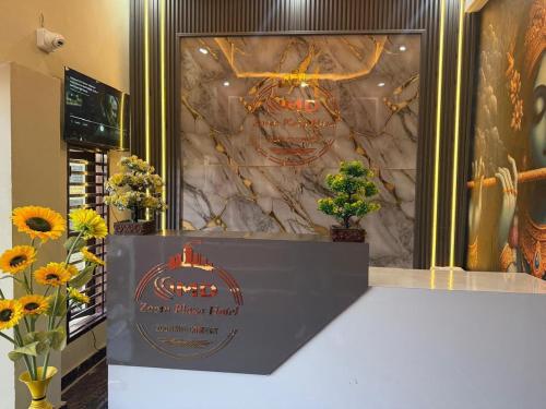 a sign for a flower shop with flowers on a counter at JMD Zoom Plaza Hotel in Farrukhnagar