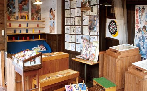 a store with wooden furniture and pictures on the wall at Yuttarino-Sato Inaka in Achi