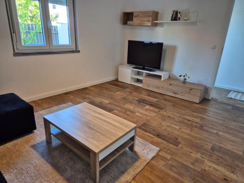 a living room with a flat screen tv and a coffee table at Flat near Serra da Arrábida, beaches and Lisbon in Quinta do Conde