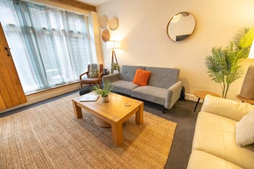 a living room with a couch and a table at The Mews - Worcester City - House - Gated - Self Check In - Free WIFI - 2 Doubles - TVs in bedrooms - Sleeps 6 - Free Nearby Parking in Worcester