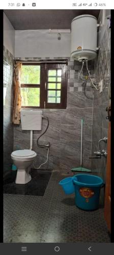 a bathroom with a toilet and a window at Paris Home Stay in Keran