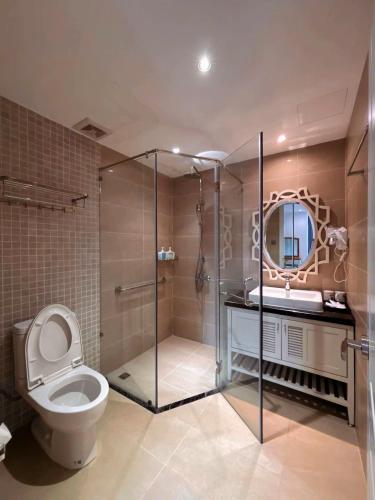 a bathroom with a toilet and a sink and a mirror at Camly Resort DaLat in Ấp Ða Lợi