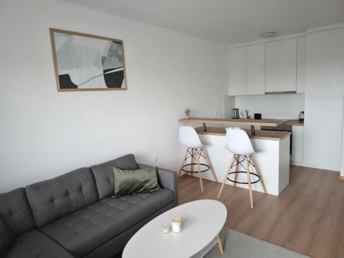 a living room with a couch and a table at Apartman Milos in Modriča