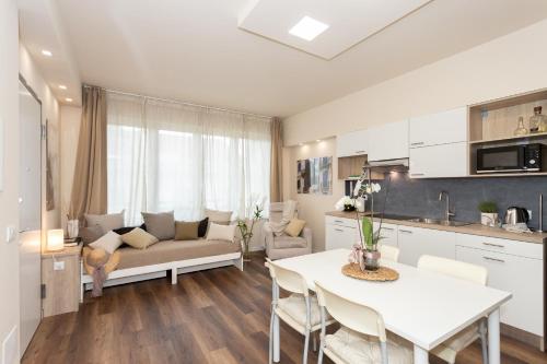 a kitchen and living room with a table and a couch at Palazzo Mazzini in Cornaredo