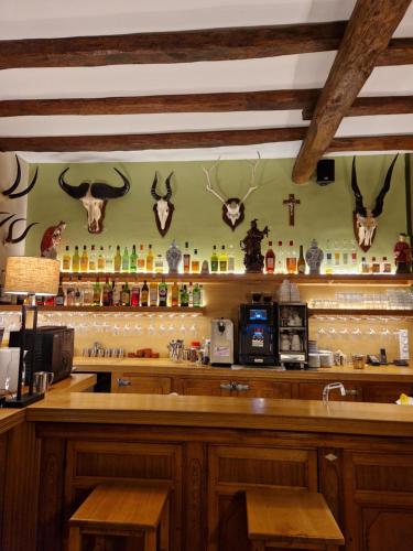 a bar with horns on the wall of a restaurant at HOTEL DE L'ABBAYE DE LONGPONT in Longpont