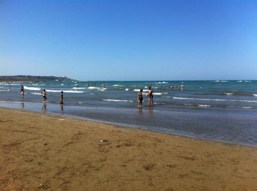 a group of people walking on the beach at Hasanovs Villa in Baku