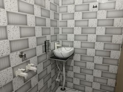 a bathroom with a sink in a brick wall at Sivago hotel in Kosi