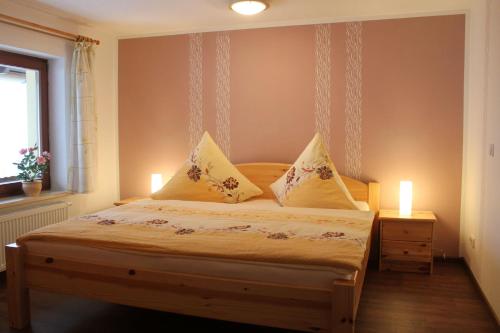 a bedroom with a bed with two candles on it at Ferienhof Leuner Sandro in Bad Schandau