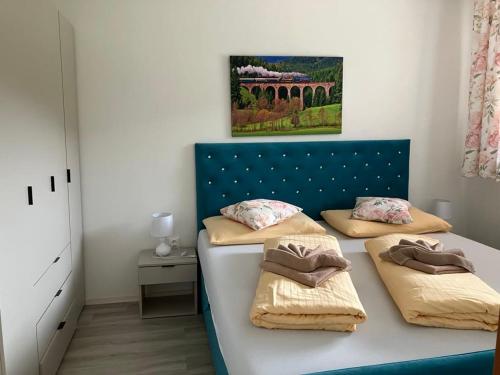 a bedroom with two beds with a blue headboard at APT 16 Telgart in Telgárt