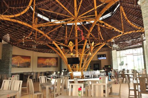 a room with tables and chairs and a large ceiling at Phurua Sanctuary Resort and Spa in Phu Rua
