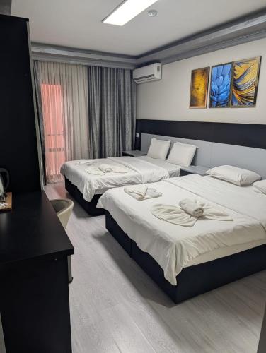 a hotel room with two beds and a desk at Retro Boutique in Istanbul