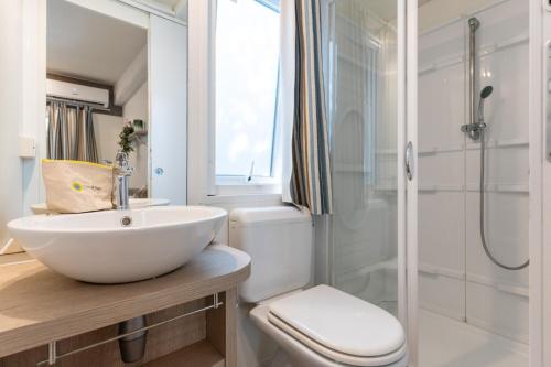a bathroom with a sink and a toilet and a shower at Club del Sole Marina Julia Family Collection in Marina Julia