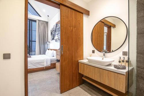 a bathroom with a sink and a mirror at Modern 2BR Villa Samudra Ocean View Nusa Dua in Ungasan