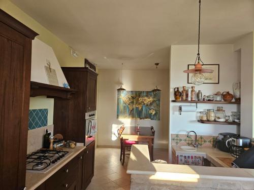 a kitchen with a sink and a stove top oven at Casa degli Angeli in Fermo