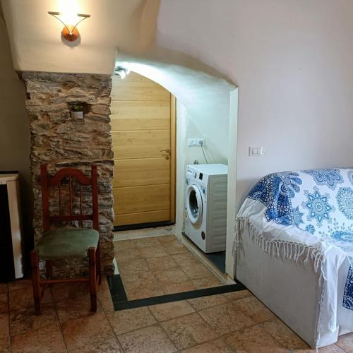 a bedroom with a bed and a stone wall at Ginestra in Cipressa