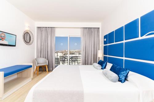 a hotel room with a large bed with blue accents at HOVIMA Cool Costa Adeje in Adeje