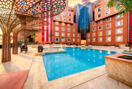 a large swimming pool in the middle of a building at The Orchid Hotel Hinjewadi Pune in Pune