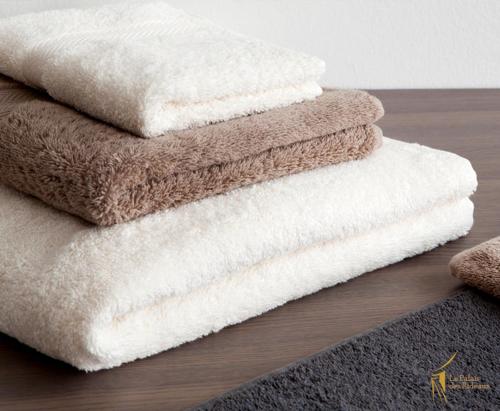a pile of towels sitting on top of a table at Panoramic 2 bedrooms Ennassr in Ariana