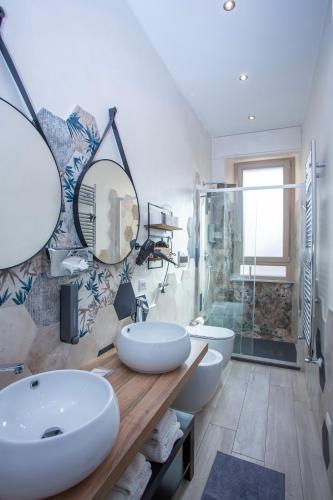 a bathroom with two sinks and a shower at Come a Casa Pretty Apartment in Lido di Ostia