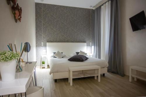 a bedroom with a large white bed and a window at Come a Casa Pretty Apartment in Lido di Ostia