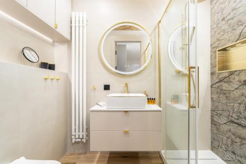 a bathroom with a sink and a mirror at Your Holidays Forest D141 in Międzyzdroje