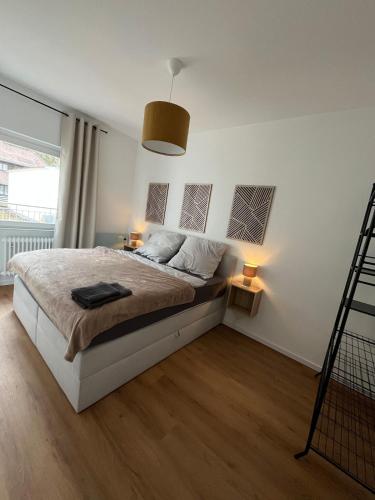 a bedroom with a large bed with two lamps at City Centre Terrace Apartment in Triberg