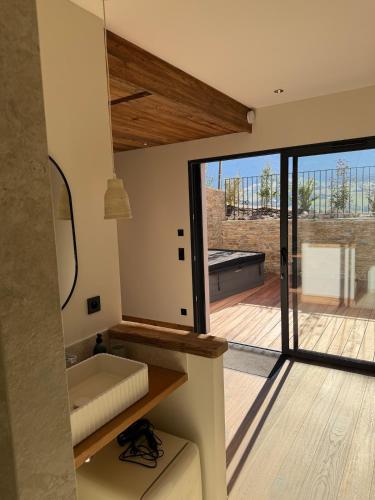 a room with a view of a deck with a large window at L'Orée du Peney in Saint-Jean-dʼArvey