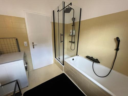 a bathroom with a shower and a bath tub at City Centre Terrace Apartment in Triberg