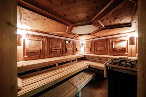 an empty sauna with wooden walls and wooden cabinets at Wellness Hotel Kager Harkány in Harkány