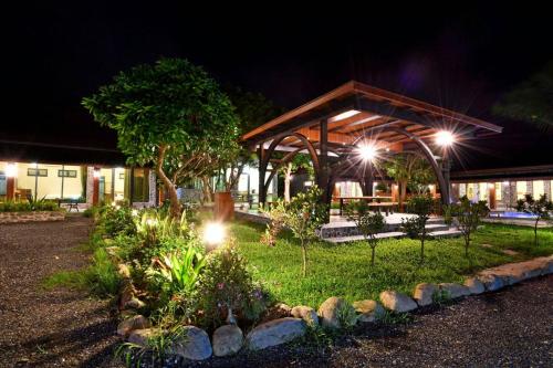 a garden at night with lights in front of a building at Kenting Four Season Villa in Hengchun