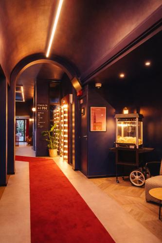 a hallway with a red carpet in a room at ClapClap Hôtel Strasbourg in Strasbourg