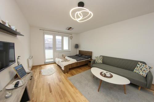 a living room with a couch and a table at Apartman Imperial 7 in Sarajevo