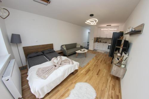 a bedroom with a bed and a living room at Apartman Imperial 7 in Sarajevo