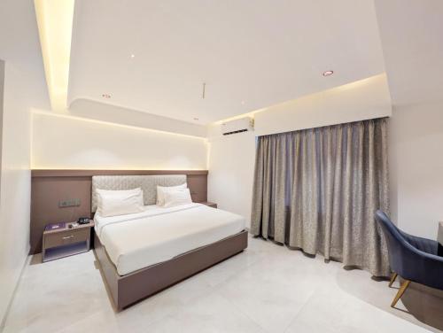 a hotel room with a bed and a window at Hotel Solaris in Indore