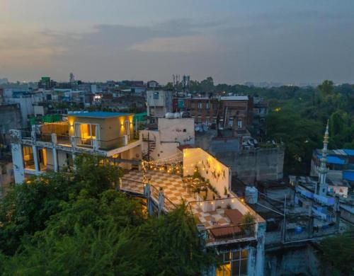 a view of a city with buildings and lights at Minimalist One Hauz Khas Village in New Delhi