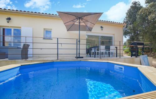 a house with a swimming pool and an umbrella at "Vigna d’Eugène" – T3 Piscine | by Efficios in Petreto-Bicchisano