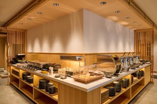 a restaurant kitchen with food on a counter at Tosei Hotel Cocone Ueno in Tokyo