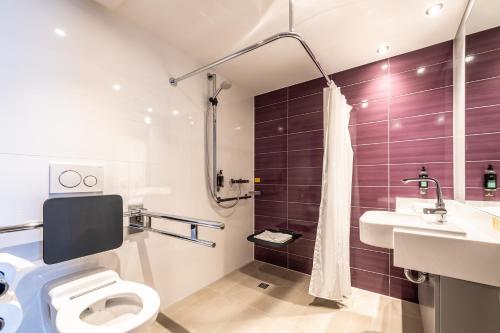 a bathroom with a toilet and a sink at Premier Inn Essen City Limbecker Platz in Essen
