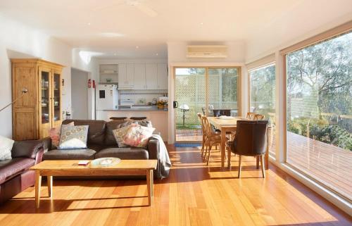 a living room with a couch and a table at Mereweather Estate Cottage in Dunkeld
