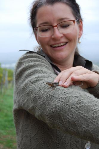 a woman with glasses holding a bug on her arm at HEINRICHs winery bed & breakfast in Langenlonsheim