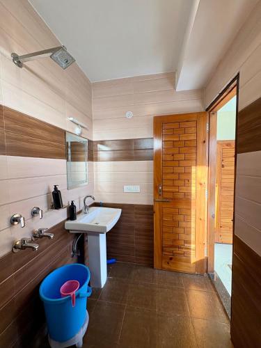 a bathroom with a sink and a toilet at Soma House Dharamkot in McLeod Ganj