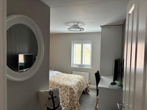 a bedroom with a bed and a mirror and a desk at Quiet double bedroom in Yapton