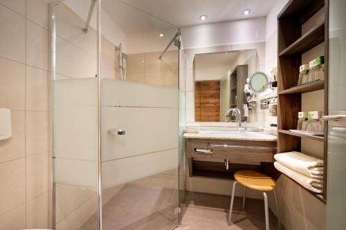 a bathroom with a shower and a sink at Hotel Sommer Füssen in Füssen