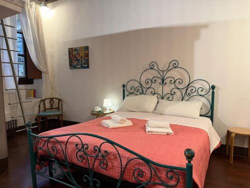 a bed with a red blanket and two towels on it at Assisi 2 by E-Roi Rent - Museo Egizio in Turin