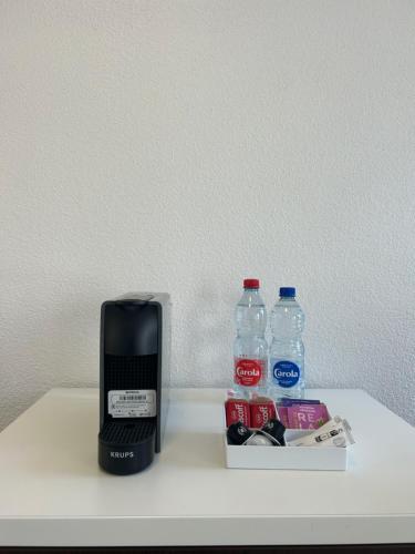 a coffee maker and water bottles on a shelf at Apparteo Strasbourg in Strasbourg