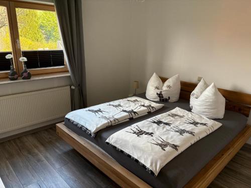 a bedroom with two beds and a window at Ferienwohnung Klara in Hilchenbach