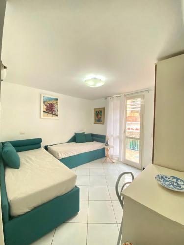 a living room with two beds and a couch at FRANCESCA'S HOUSE in Minori